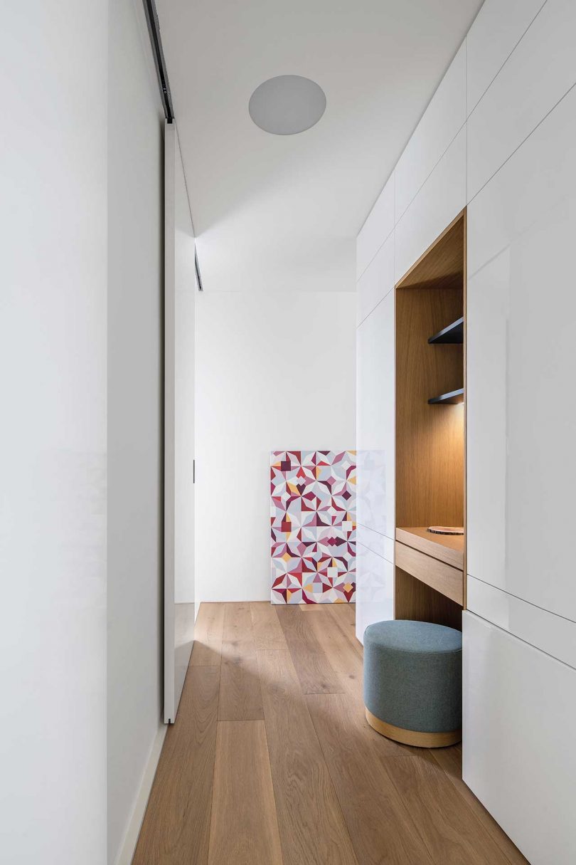 white hallway with closets and built-in vanity