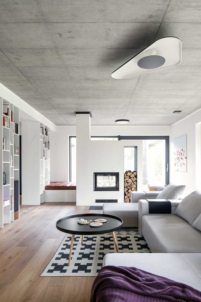 modern living room in concrete, wood, and white surfaces