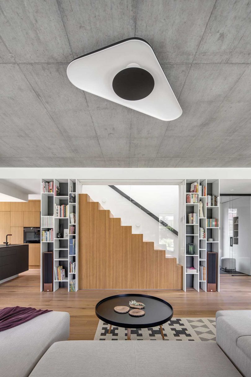 modern living room in concrete, wood, and white surfaces