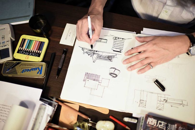 man sketching in a journal