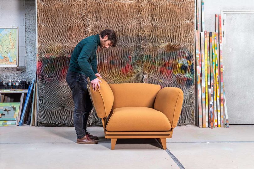 Man sliding sofa arm onto sofa