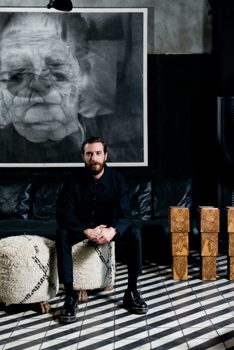 man posing for portrait sitting on stool