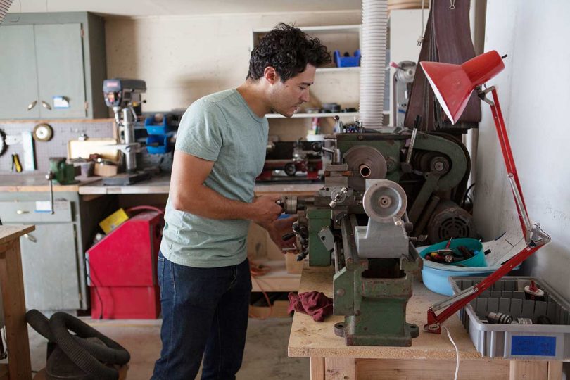 man working in woodshop on a power tool