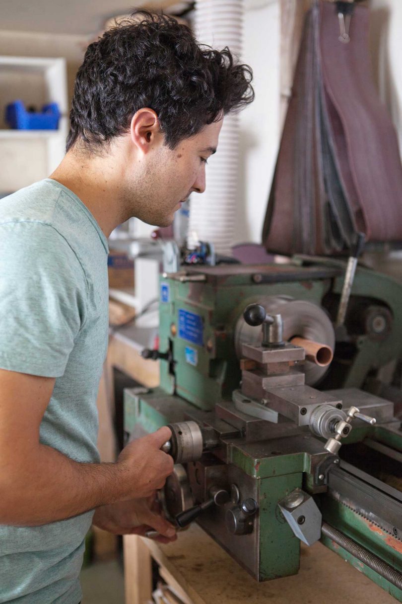 man working on lathe in tool shop