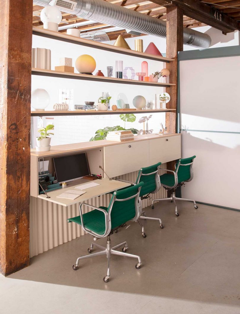 row of computer desks with green chairs