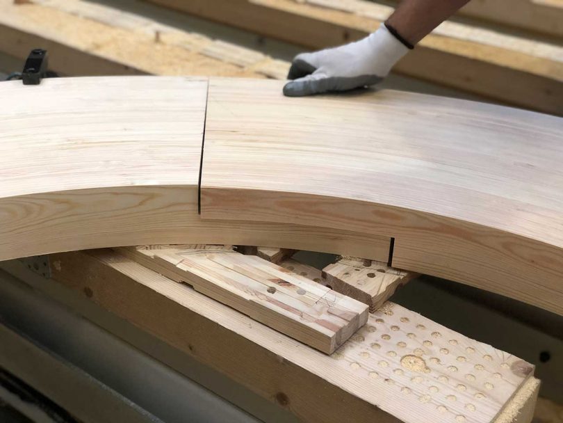 curved wooden components being fit together during build