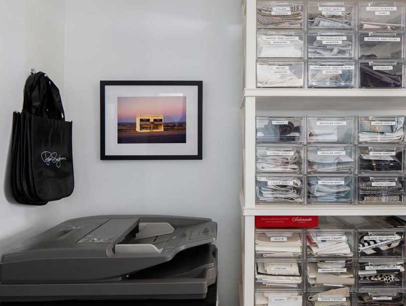 corner of office with photocopier and shelf with supples