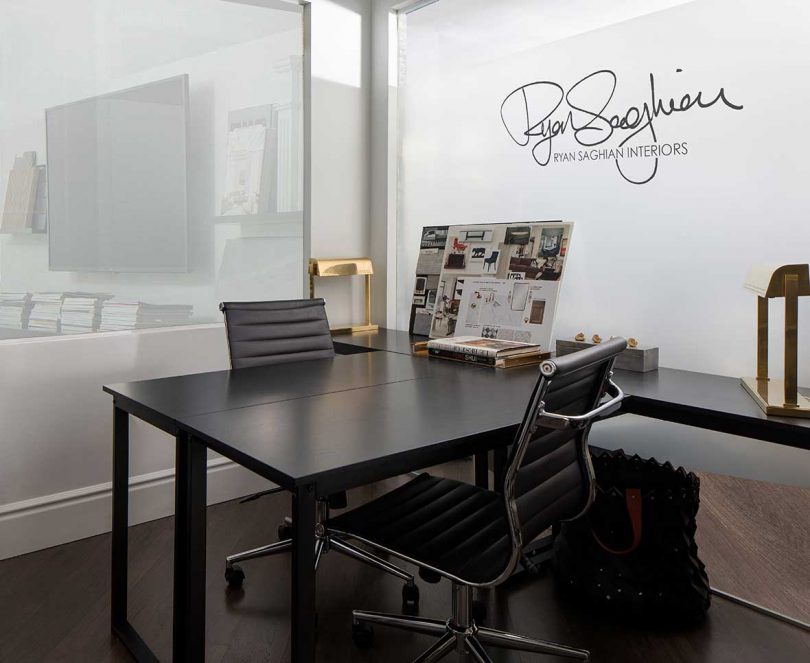 dark empty desk with two office chairs