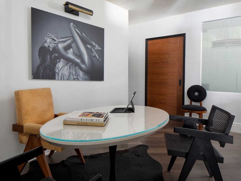 modern office with oval desk and assorted chairs