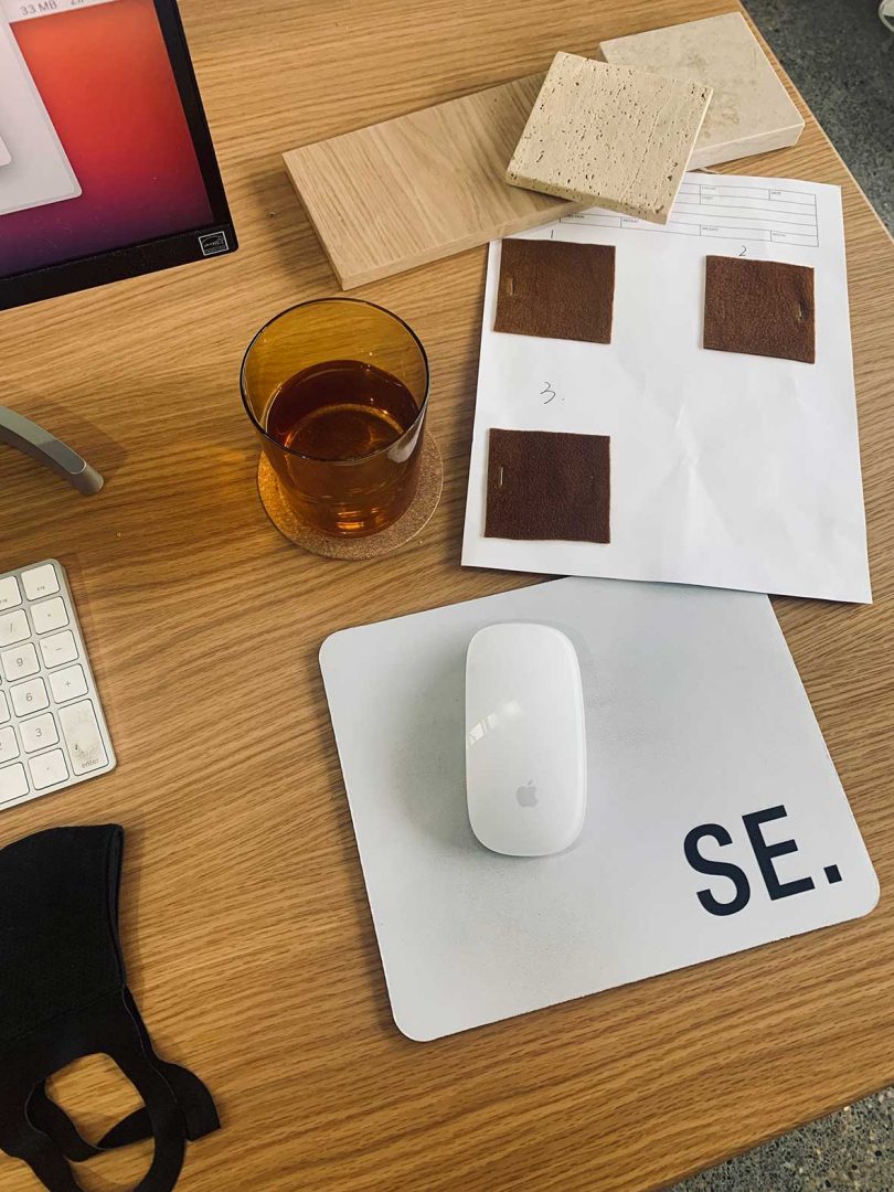 view of desk with branded mousepad and material samples