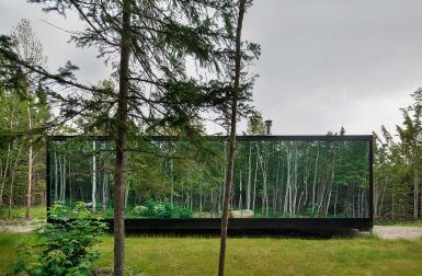 A Compact, Modern Cabin in the Woods That Reflects the Trees