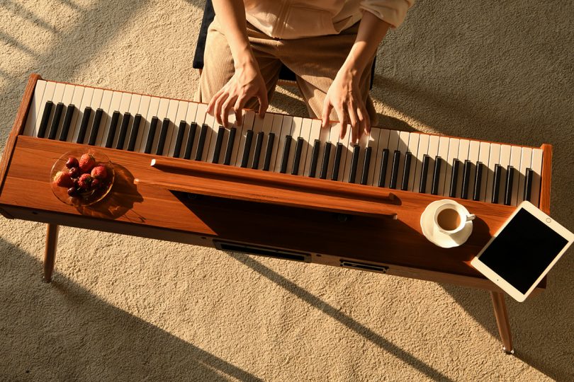 overhead shot of hands playing a digital piano