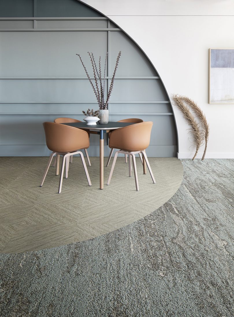 interior space with neutral colored table and chairs, walls, and floor covering