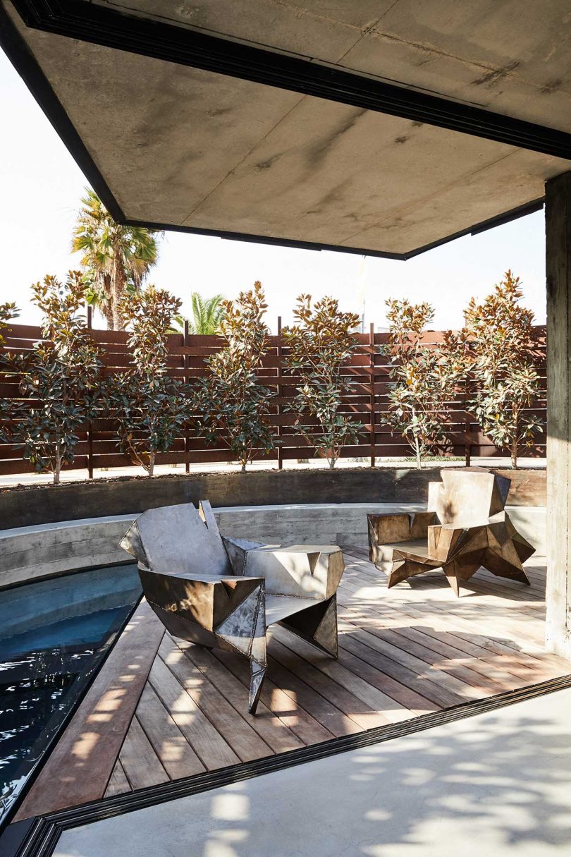 exterior view from modern deck overlooking curved pool