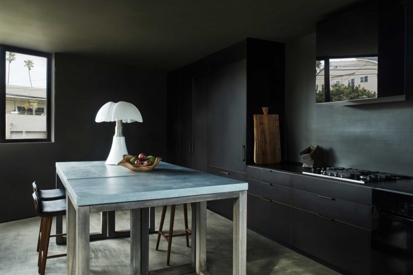 interior of modern dark kitchen with glass tabletop