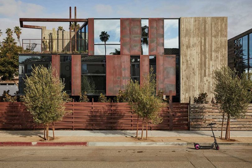 closeup sideview of modern house with rust red and patinaed wood details