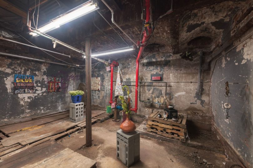 Basement installation of sculpture in "Made to Be Broken" exhibition