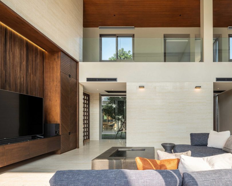 interior shot of modern double-height living rom with l-shaped sofa