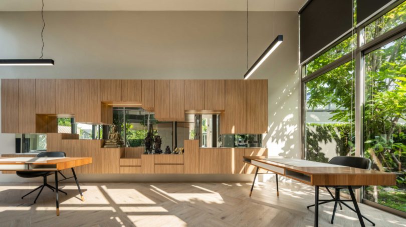 interior view of large modern home office with built-in storage and two desks