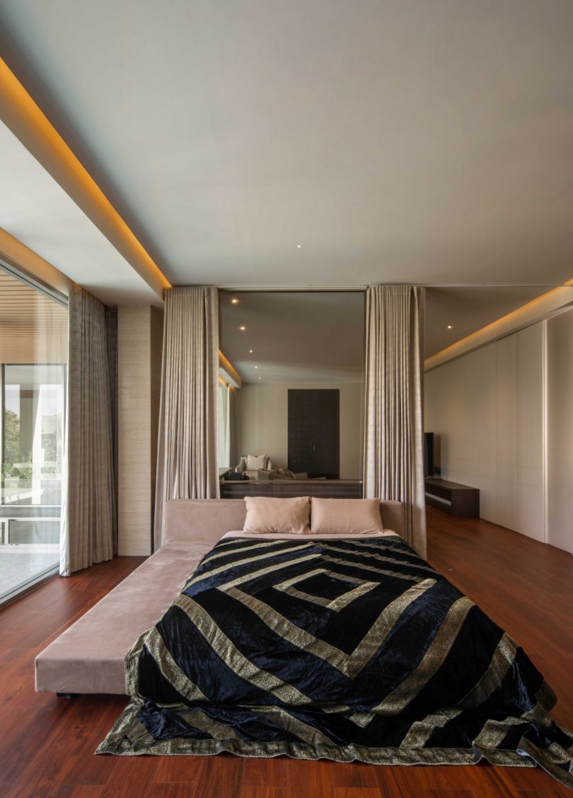 shot of bedroom with patterned blanket on bed