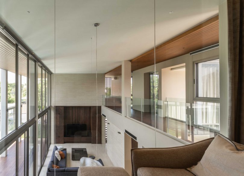 upstairs view looking down into double-height modern living room