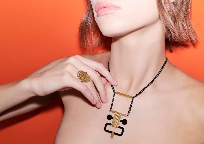 light-skinned woman with shoulder-length light colored hair wearing modern jewelry