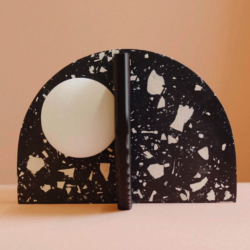 closeup of semi-circular black and white terrazzo XOU light