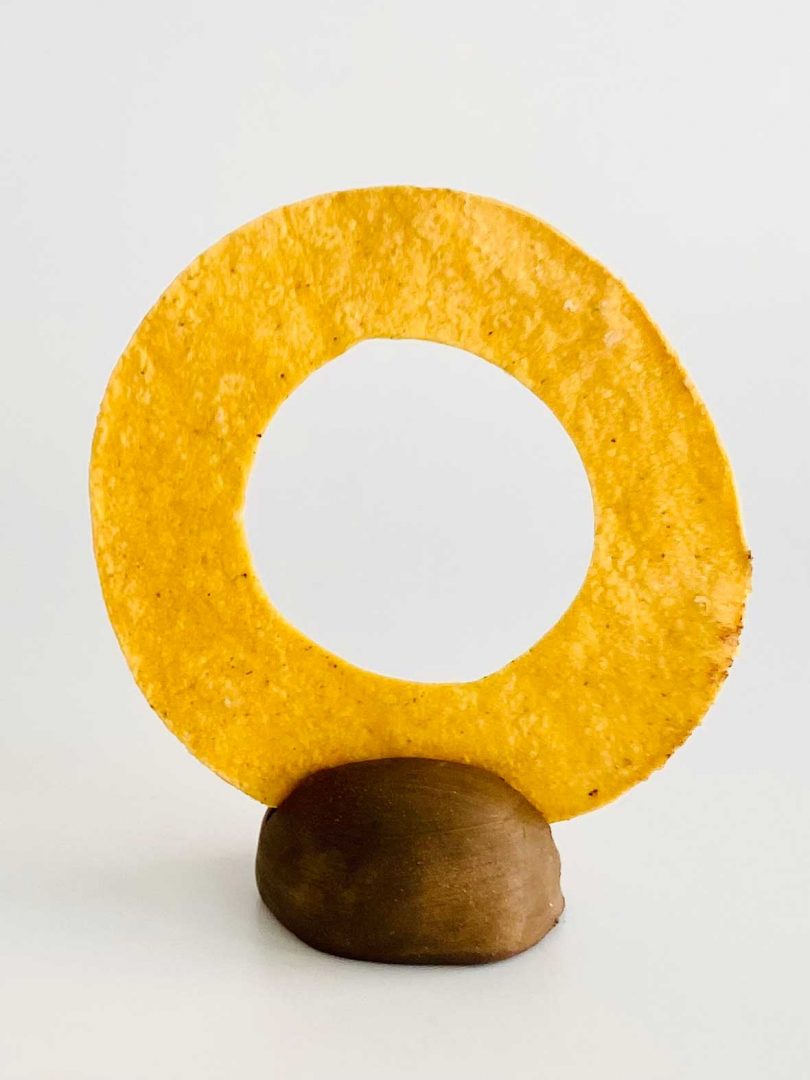 Tortilla with circle cut out standing on pedestal