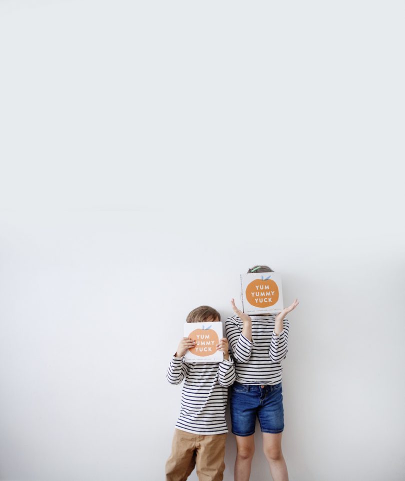 two kids holding books