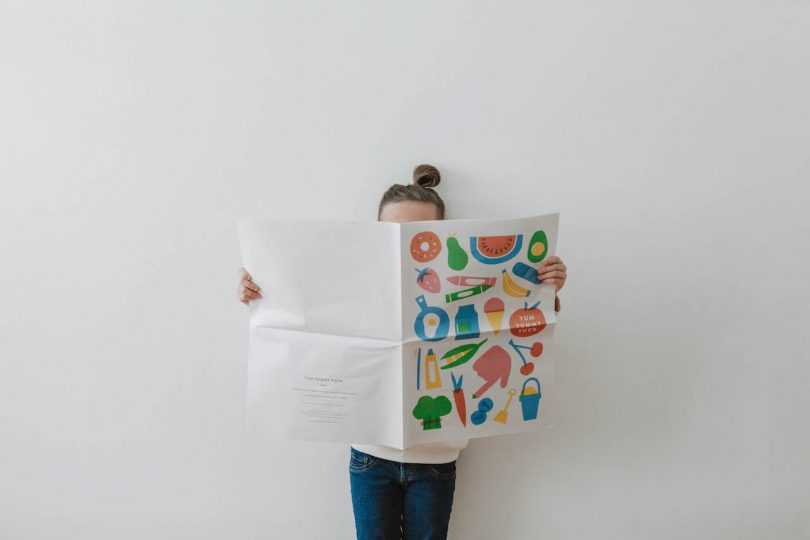 girl holding newspaper