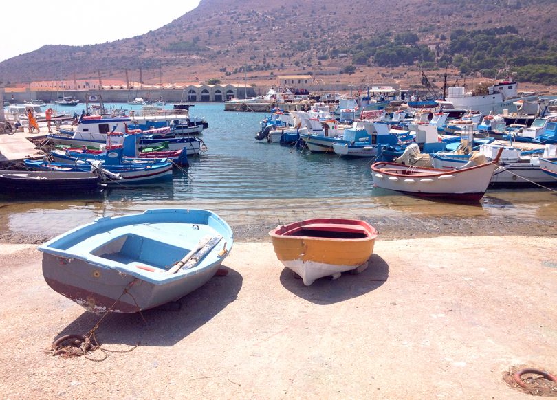 island coast in Italy with docked boats