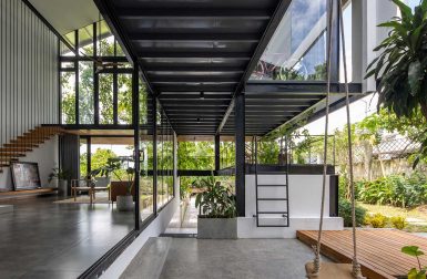 A Glass-Stacked House in Vietnam Shrouded in Greenery