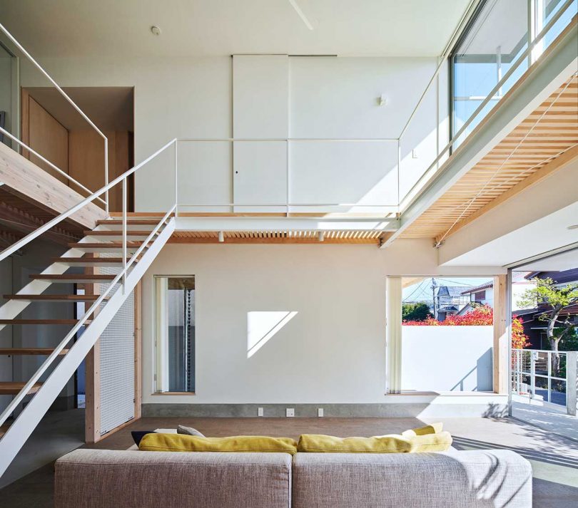 interior of modern Japanese home with double height living room with staircase