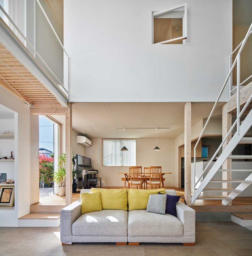 interior of modern Japanese home with double height living room with staircase