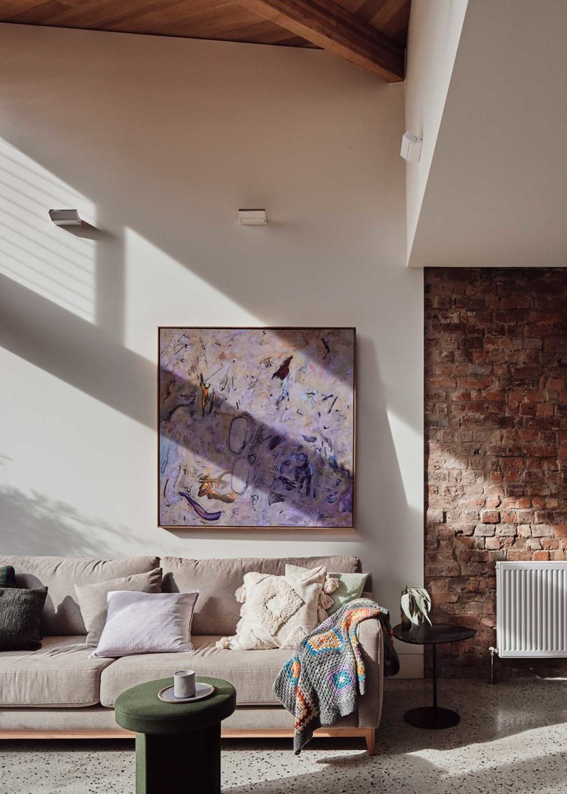 interior view of modern living rom with sofa and painting above