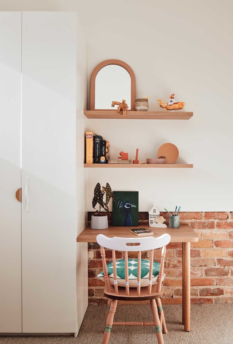 small desk with chair and shelves above