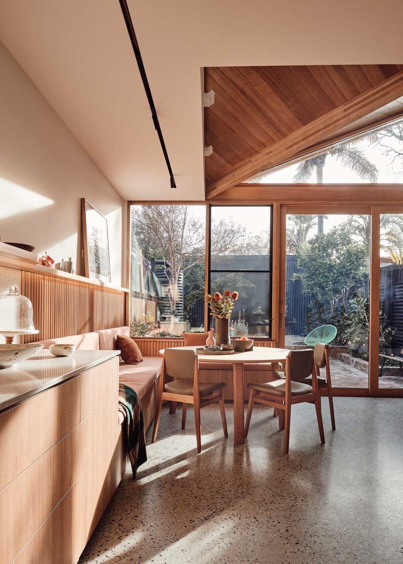 interior view of modern dining area with wood table and built-in seating