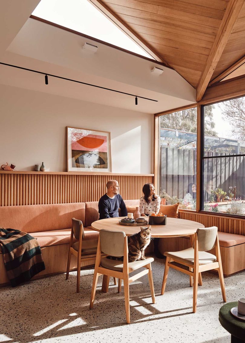 interior view of modern dining area with wood table and built-in seating