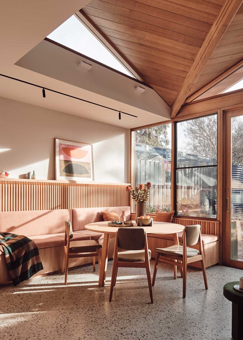 interior view of modern dining area with wood table and built-in seating