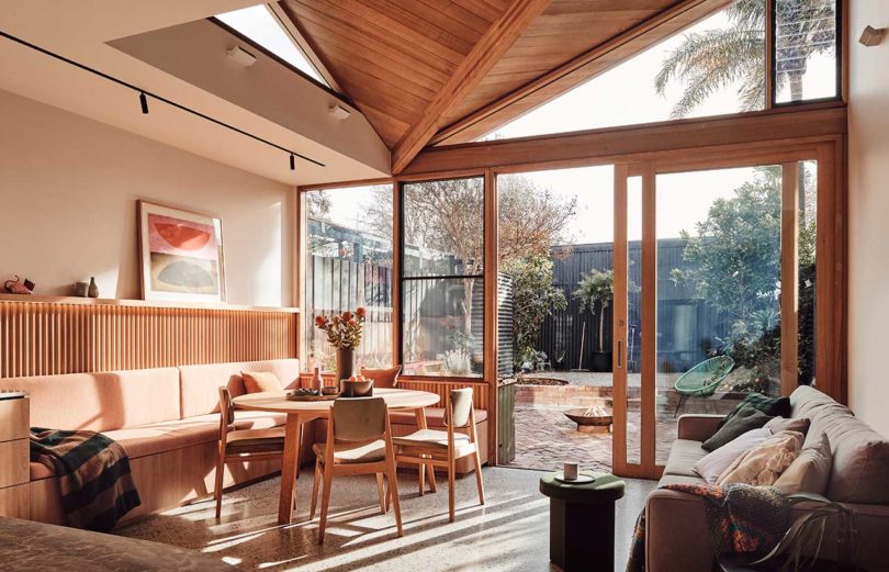 interior view of modern dining area with wood table and built-in seating