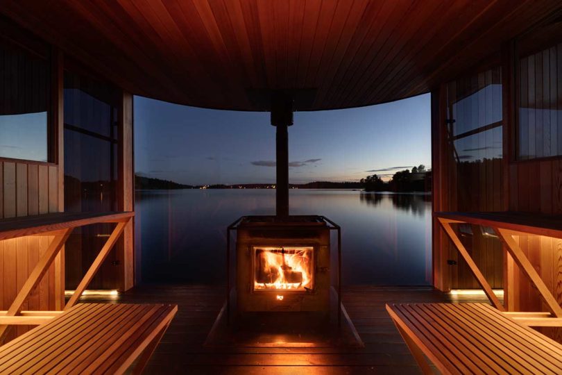 twilight view of modern wooden floating sauna on water