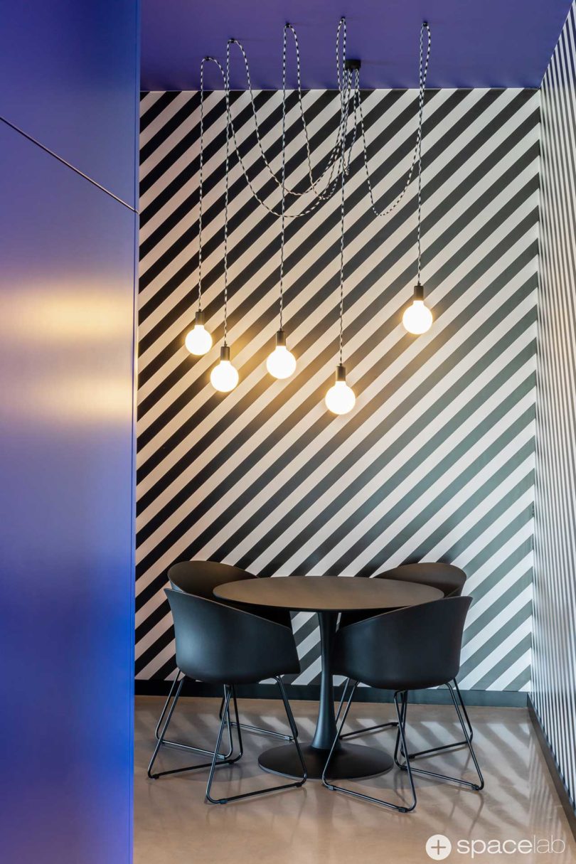 modern office interior with bold purple accents and diagonal black and white stripes