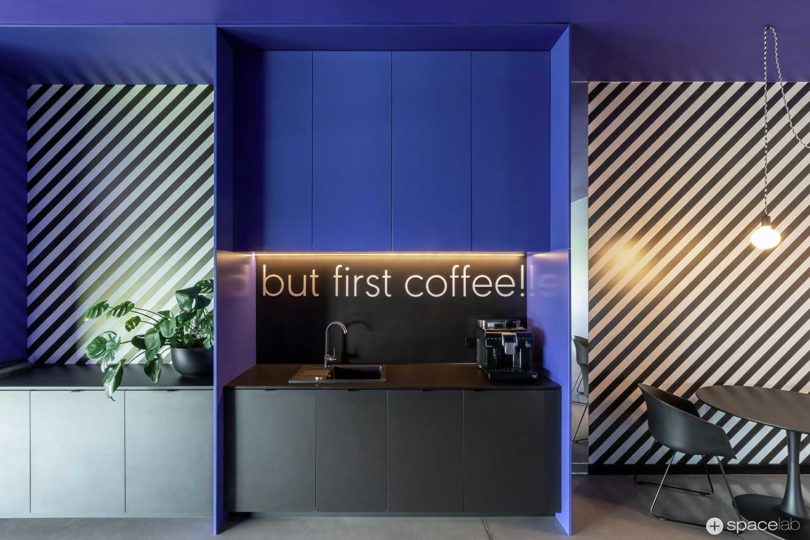 modern office interior with bold purple accents and diagonal black and white stripes