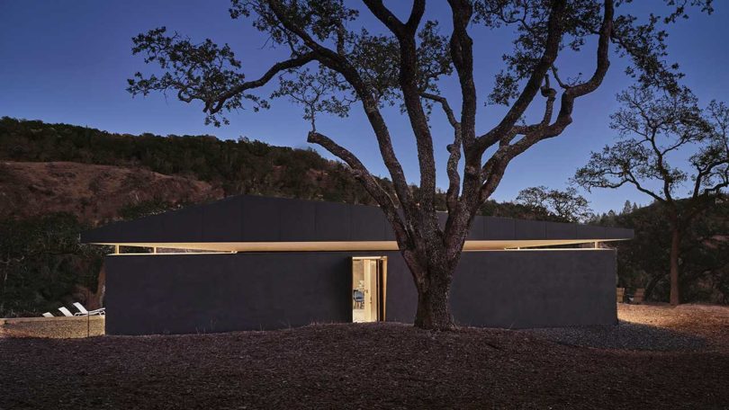 evening view of exterior view of small modern black house