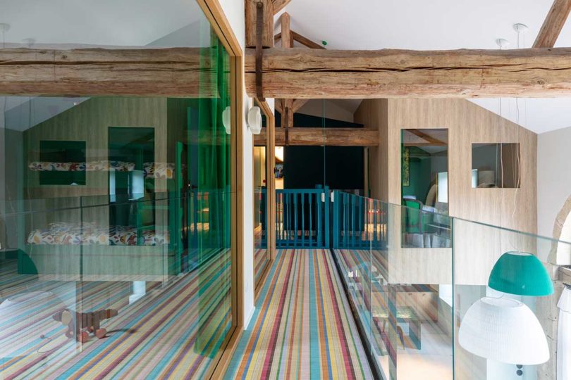 upstairs balcony hallway with striped carpet