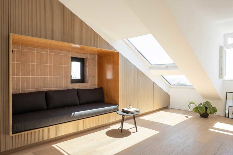 attic apartment with slanted ceilings and built-in sofa