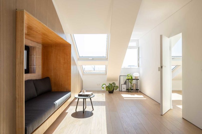 attic apartment with slanted ceilings and built-in sofa