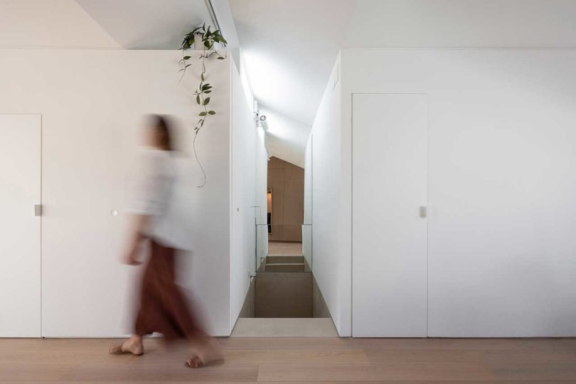 woman walking by white wall in apartment