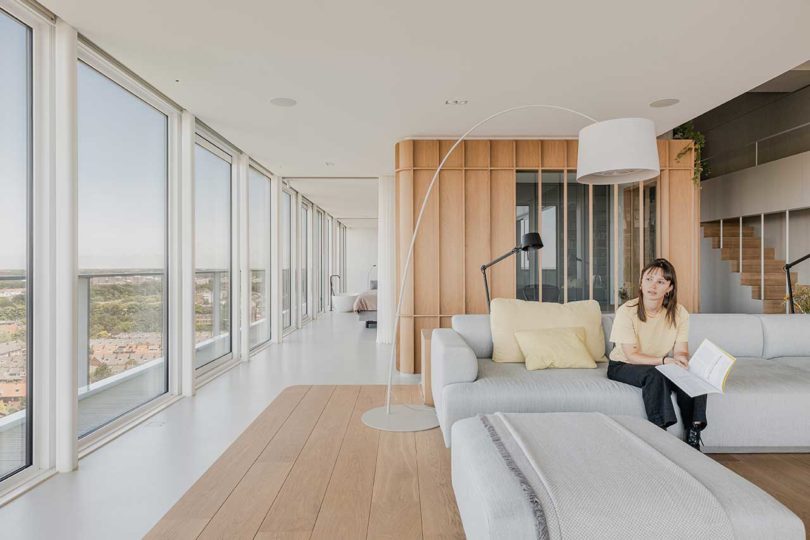 corner interior view of modern penthouse apartment with raised wooden platform for sofa