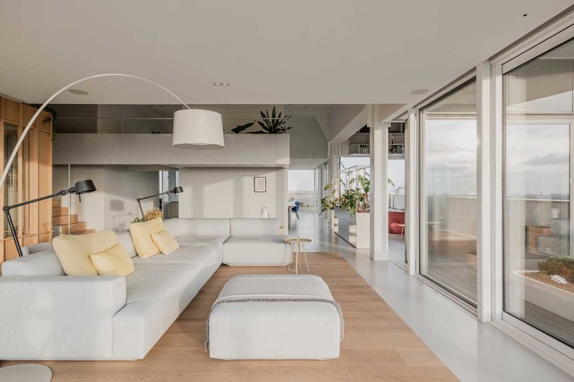 corner interior view of modern penthouse apartment with raised wooden platform for sofa